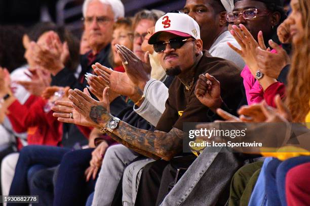 Singer Chris Brown cheers during the women's college basketball game between the UCLA Bruins and the USC Trojans on January 14, 2023 at Galen Center...