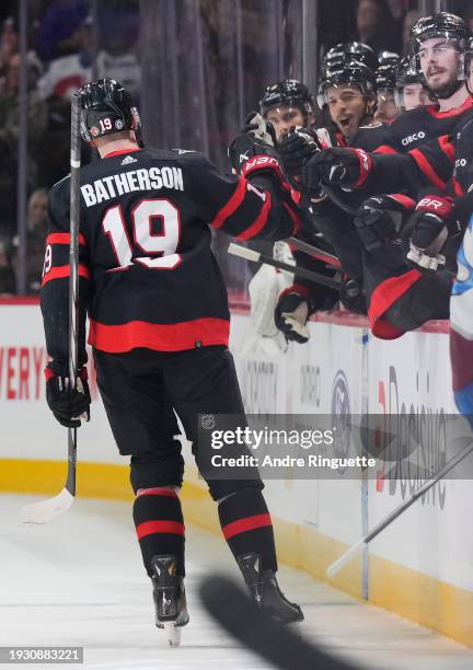 Drake Batherson of the Ottawa Senators celebrates his first period goal against the Colorado Avalanche with teammates at the players' bench at...