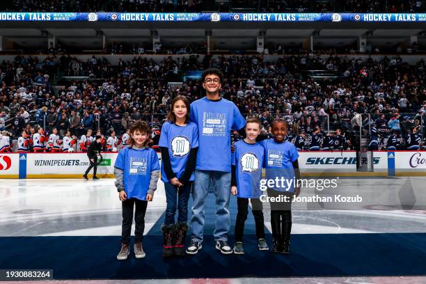 Maksym MacLean, Sophia Young, Megh Modha, Harvey Farrell and Deborah Chukwu pose during the pre-game ceremony as they represent Hockey Talks Night...