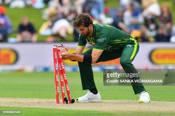 Pakistan's Shaheen Shah Afridi removes bails to dismiss New Zealand's Mitchell Santner during the third Twenty20 international cricket match between...