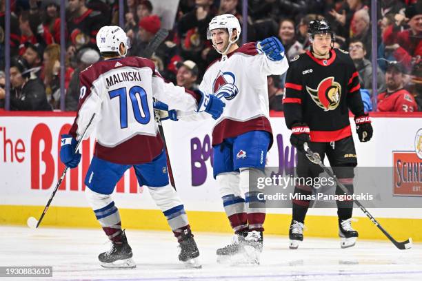 Jason Polin of the Colorado Avalanche celebrates his goal with teammate Sam Malinski during the second period against the Ottawa Senators at Canadian...