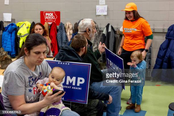 Ron DeSantis precinct captain Deborah Stoner, formerly of Huntington Beach, now living in Ames, Iowa, right, speaks with a Trump supporter during the...