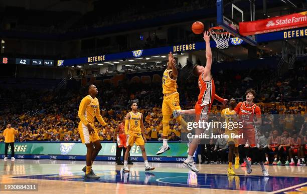 Justin Taylor of the Syracuse Orange drives to the basket past William Jeffress of the Pittsburgh Panthers in the second half during the game at...