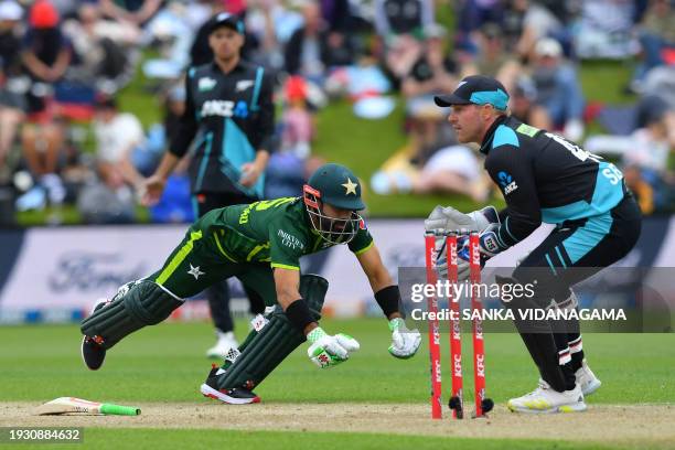 Pakistan's Mohammad Rizwan dives for his crease as New Zealand's wicketkeeper Tim Seifert fields the ball during the third Twenty20 international...