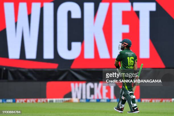 Pakistan's Mohammad Rizwan walks back to the pavilion after his dismissal during the third Twenty20 international cricket match between New Zealand...