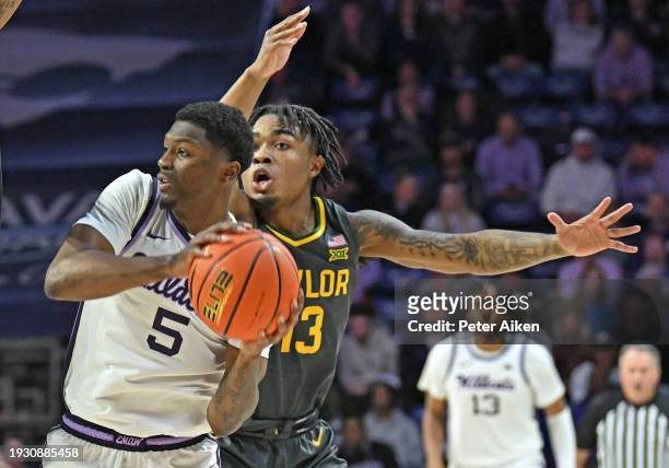 Cam Carter of the Kansas State Wildcats gets pressure from Langston Love of the Baylor Bears in the second half at Bramlage Coliseum on January 16,...