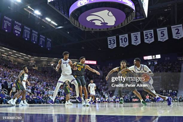 Cam Carter of the Kansas State Wildcats drives to the basket against Langston Love of the Baylor Bears in the second half at Bramlage Coliseum on...