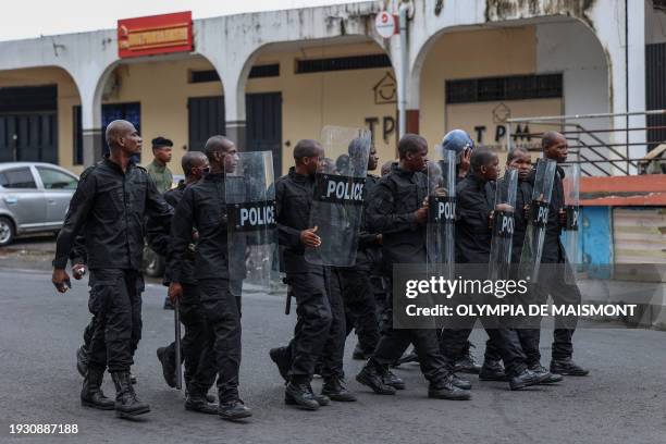 Comoros police officers move in formation during a demonstration by opposition supporters in Moroni on January 17, 2024. Former coup leader Azali...