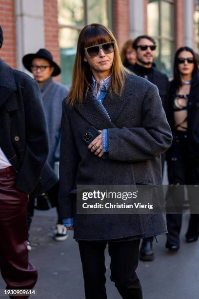 Guest wears grey oversized jacket outside Fendi during the Milan Fashion Week - Menswear Fall/Winter 2024-2025 on January 13, 2024 in Milan, Italy.