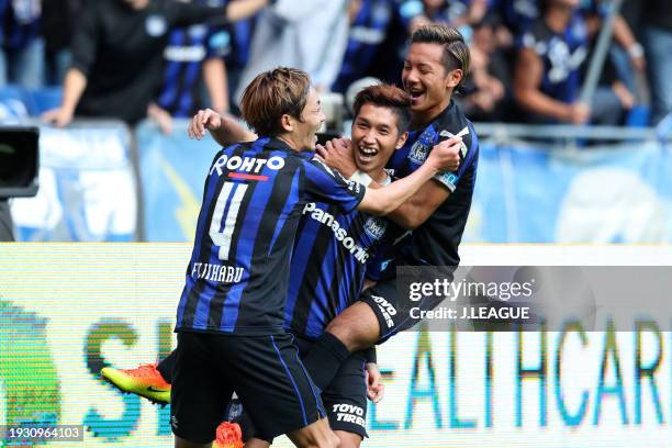 Hiroto Goya of Gamba Osaka celebrates with teammates Hiroki Fujiharu and Yosuke Ideguchi after scoring the team's third goal during the J.League J1...