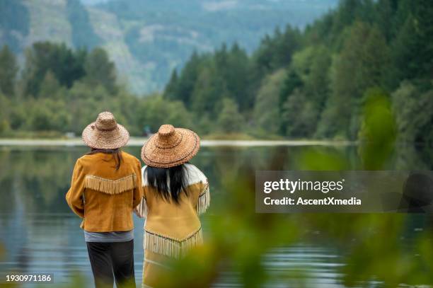 indigenous women enjoy lake together - indigenous peoples of the americas stock pictures, royalty-free photos & images