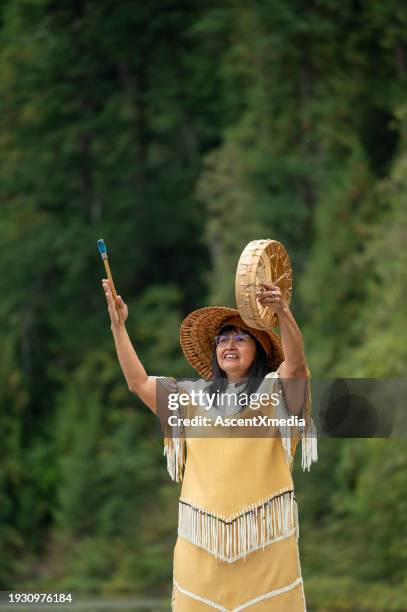 portrait of indigenous woman with drum in forest - indigenous american culture stock pictures, royalty-free photos & images