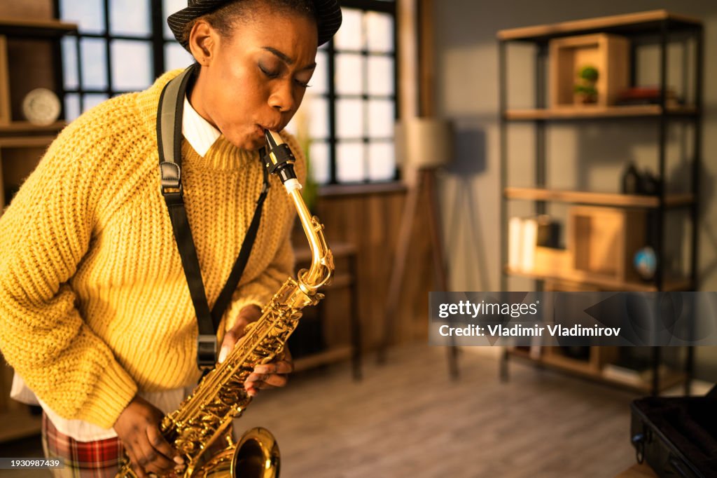 A woman is practising on her saxophone