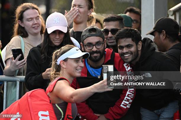 Spain's Paula Badosa takes selfies with fans as she celebrates her victory against Russia's Anastasia Pavlyuchenkova after the women's singles match...