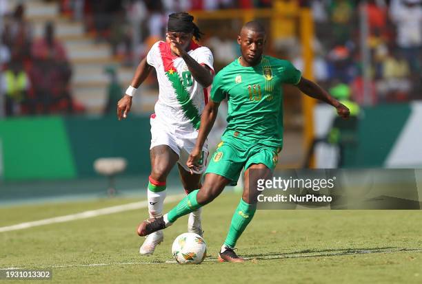 Idrissa Thiam of Mauritania is fighting for the ball with Bertrand Isidore Traore of Burkina Faso during the 2024 Africa Cup of Nations Group D...