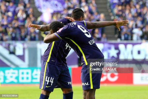 Anderson Lopes of Sanfrecce Hiroshima celebrates with teammate Peter Utaka after scoring the team's third goal during the J.League J1 second stage...