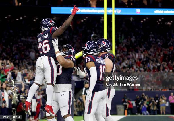 Devin Singletary of the Houston Texans celebrates with teammates after scoring a 19 yard touchdown against the Cleveland Browns during the fourth...