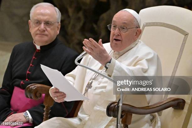 Pope Francis delivers a speech next to Prefect of the Pontifical House, Monsignor Leonardo Sapienza during the weekly general audience at Paul-VI...