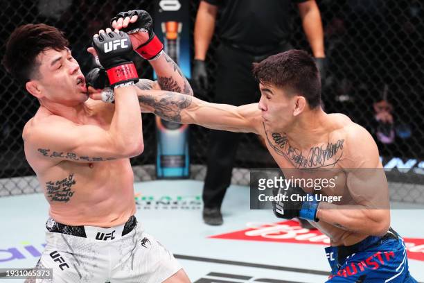 Mario Bautista punches Ricky Simon in a bantamweight fight during the UFC Fight Night event at UFC APEX on January 13, 2024 in Las Vegas, Nevada.