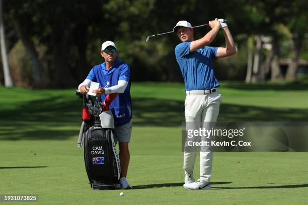 Cameron Davis of Australia plays a shot on the sixth hole while caddie, Andrew Tschudin, watches during the third round of the Sony Open in Hawaii at...