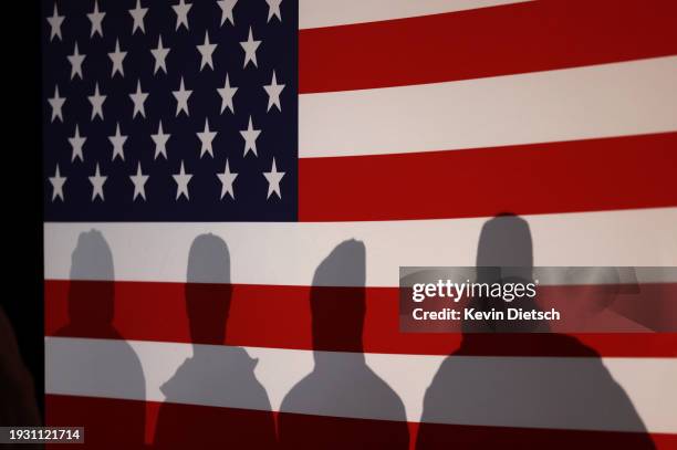 Supporters listen as Republican presidential candidate Florida Gov. Ron DeSantis speaks at a campaign event at The Grass Wagon on January 13, 2024 in...