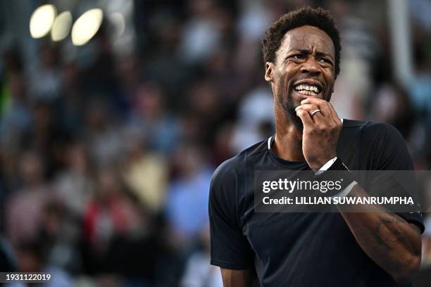 France's Gael Monfils reacts after a point against Argentina's Tomas Etcheverry during their men's singles match on day four of the Australian Open...