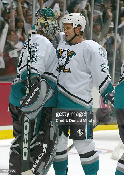 Ruslan Salei of the Mighty Ducks of Anaheim congratulates teammate Jean-Sebastien Giguere after a game 3 victory over the Detroit Red Wings during...