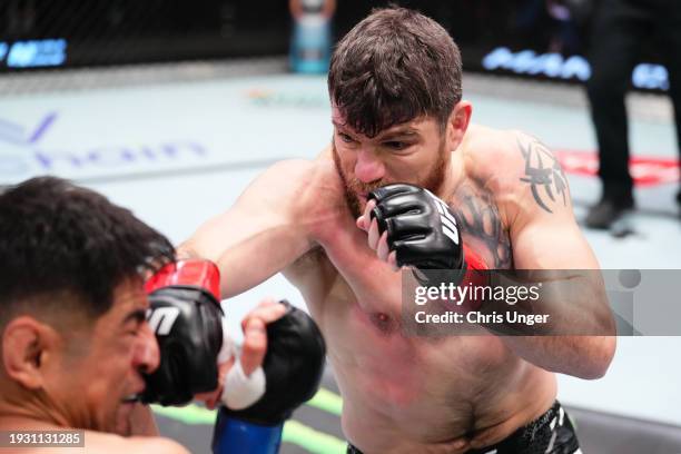 Jim Miller punches Gabriel Benitez of Mexico in a lightweight fight during the UFC Fight Night event at UFC APEX on January 13, 2024 in Las Vegas,...