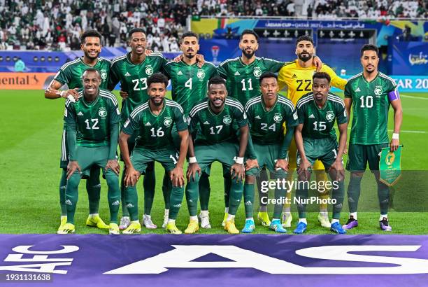 The Saudi Arabia national team players are posing for a team photo before the AFC Asian Cup 2023 match between Saudi Arabia and Oman at Khalifa...