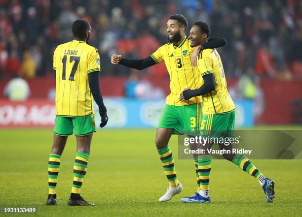 Damion Lowe, Michael Hector and Ethan Pinnock of Jamaica celebrate victory over Canada during a CONCACAF Nations League match at BMO Field on...