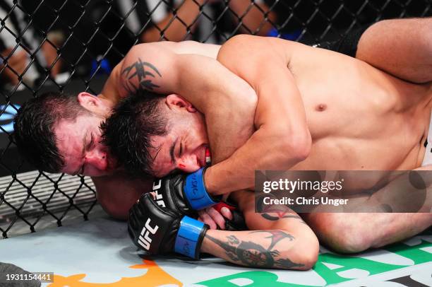 Jim Miller secures a submission against Gabriel Benitez of Mexico in a lightweight fight during the UFC Fight Night event at UFC APEX on January 13,...