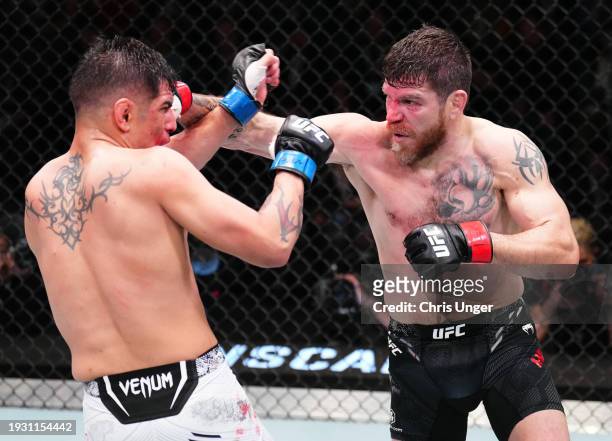 Jim Miller punches Gabriel Benitez of Mexico in a lightweight fight during the UFC Fight Night event at UFC APEX on January 13, 2024 in Las Vegas,...