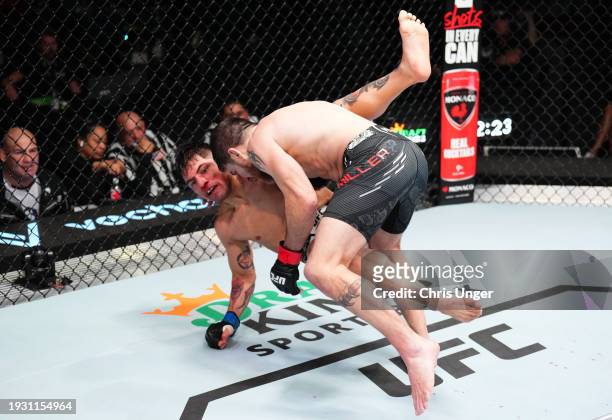 Jim Miller takes down Gabriel Benitez of Mexico in a lightweight fight during the UFC Fight Night event at UFC APEX on January 13, 2024 in Las Vegas,...