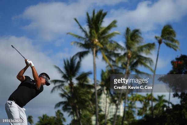 Carl Yuan of China plays his shot from the tenth tee during the third round of the Sony Open in Hawaii at Waialae Country Club on January 13, 2024 in...