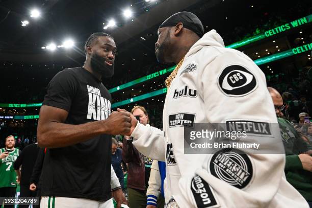 Jaylen Brown of the Boston Celtics talks with Curtis "50 Cent" Jackson after a game against the Houston Rockets at the TD Garden on January 13, 2024...