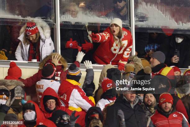 Taylor Swift celebrates with fans during the AFC Wild Card Playoffs between the Miami Dolphins and the Kansas City Chiefs at GEHA Field at Arrowhead...