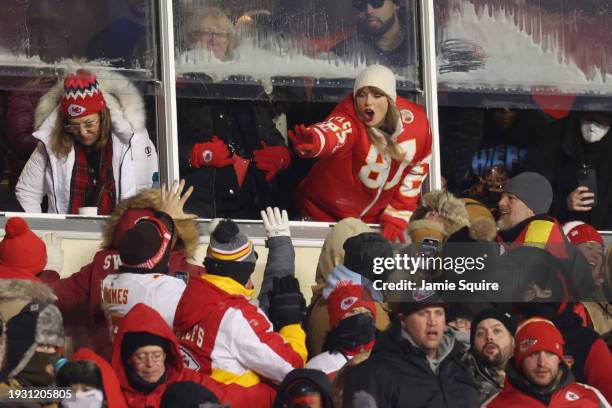 Taylor Swift celebrates with fans during the AFC Wild Card Playoffs between the Miami Dolphins and the Kansas City Chiefs at GEHA Field at Arrowhead...