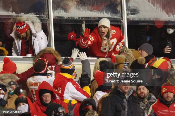 Taylor Swift celebrates with fans during the AFC Wild Card Playoffs between the Miami Dolphins and the Kansas City Chiefs at GEHA Field at Arrowhead...