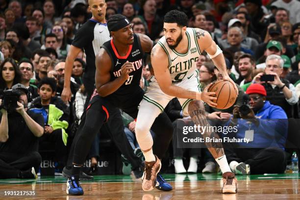 Jayson Tatum of the Boston Celtics drives to the basket against Aaron Holiday of the Houston Rockets during the fourth quarter at the TD Garden on...