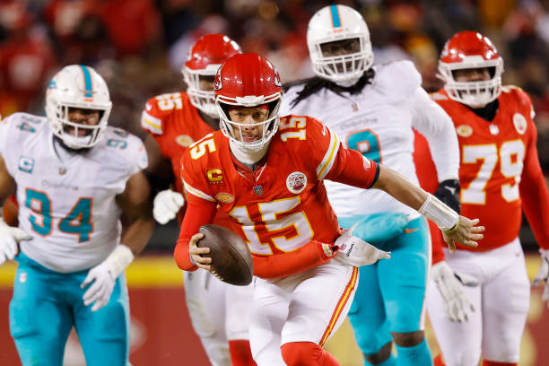 Patrick Mahomes of the Kansas City Chiefs runs with the ball during the first half against the Miami Dolphins in the AFC Wild Card Playoffs at GEHA...