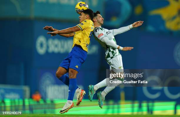 Mateus Fernandes of GD Estoril Praia with Pedro Aparicio of Moreirense FC in action during the Liga Portugal Betclic match between GD Estoril Praia...