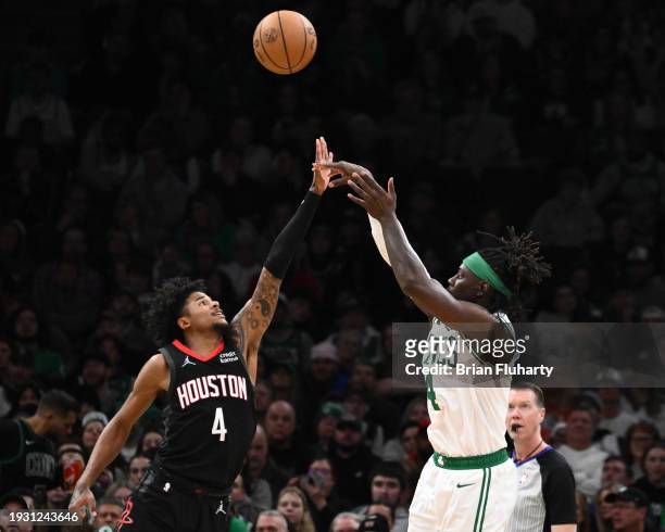 Jrue Holiday of the Boston Celtics attempts a three-point basket past Jalen Green of the Houston Rockets during the third quarter at the TD Garden on...
