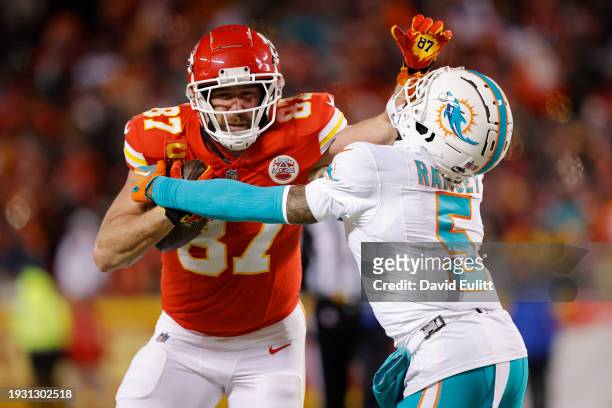 Travis Kelce of the Kansas City Chiefs stiff arms Jalen Ramsey of the Miami Dolphins during the third quarter in the AFC Wild Card Playoffs at GEHA...