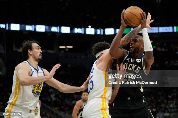 Lester Quinones of the Golden State Warriors fouls Khris Middleton of the Milwaukee Bucks in the second half at Fiserv Forum on January 13, 2024 in...