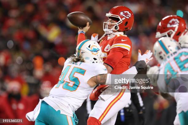 Patrick Mahomes of the Kansas City Chiefs is hit by Duke Riley of the Miami Dolphins as he throws a pass during the second half in the AFC Wild Card...