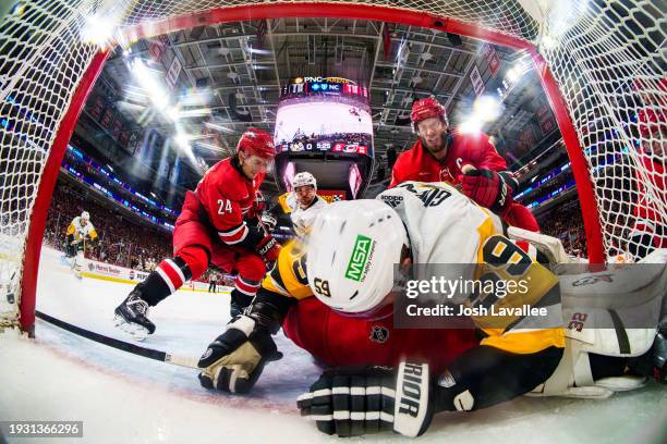 Jordan Staal of the Carolina Hurricanes goes after Jake Guentzel of the Pittsburgh Penguins after a collision with Antti Raanta during the second...