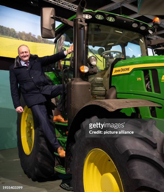 January 2024, Berlin: Joachim Rukwied, President of the German Farmers' Association, climbed onto a John Deere tractor during a press event organized...