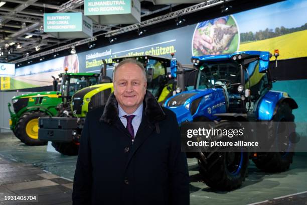 January 2024, Berlin: Joachim Rukwied, President of the German Farmers' Association, stands in front of three tractors during a press event organized...