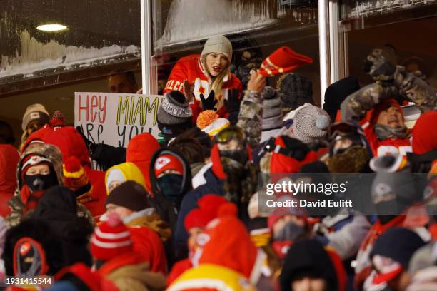 Taylor Swift celebrates with fans during the AFC Wild Card Playoffs between the Miami Dolphins and the Kansas City Chiefs at GEHA Field at Arrowhead...