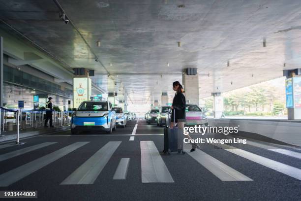 young woman crossing zebra crossing - xiamen stock pictures, royalty-free photos & images